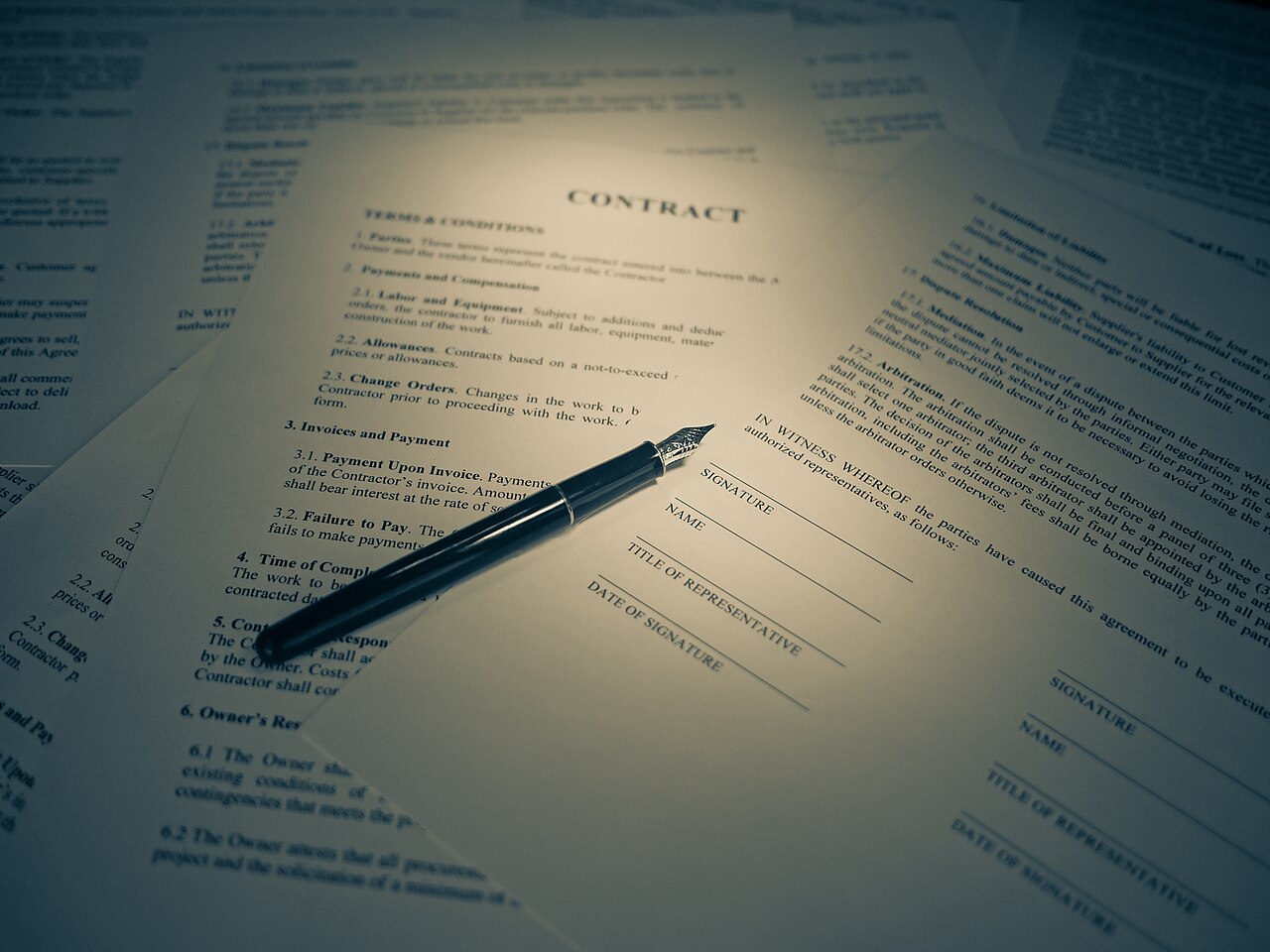 A contract being signed with a pen