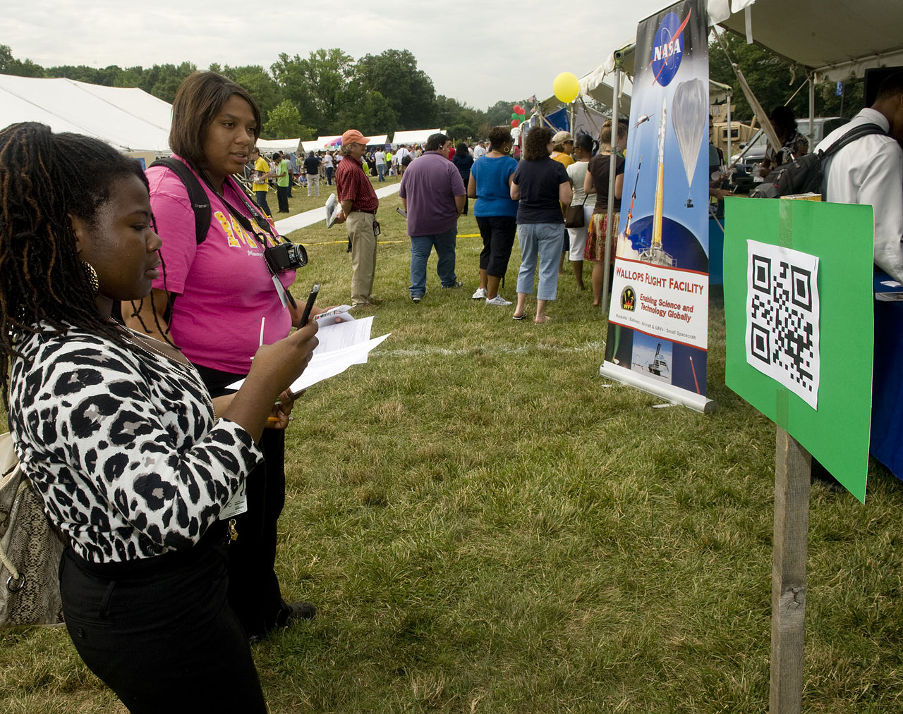 A smartphone scanning a printed QR code
