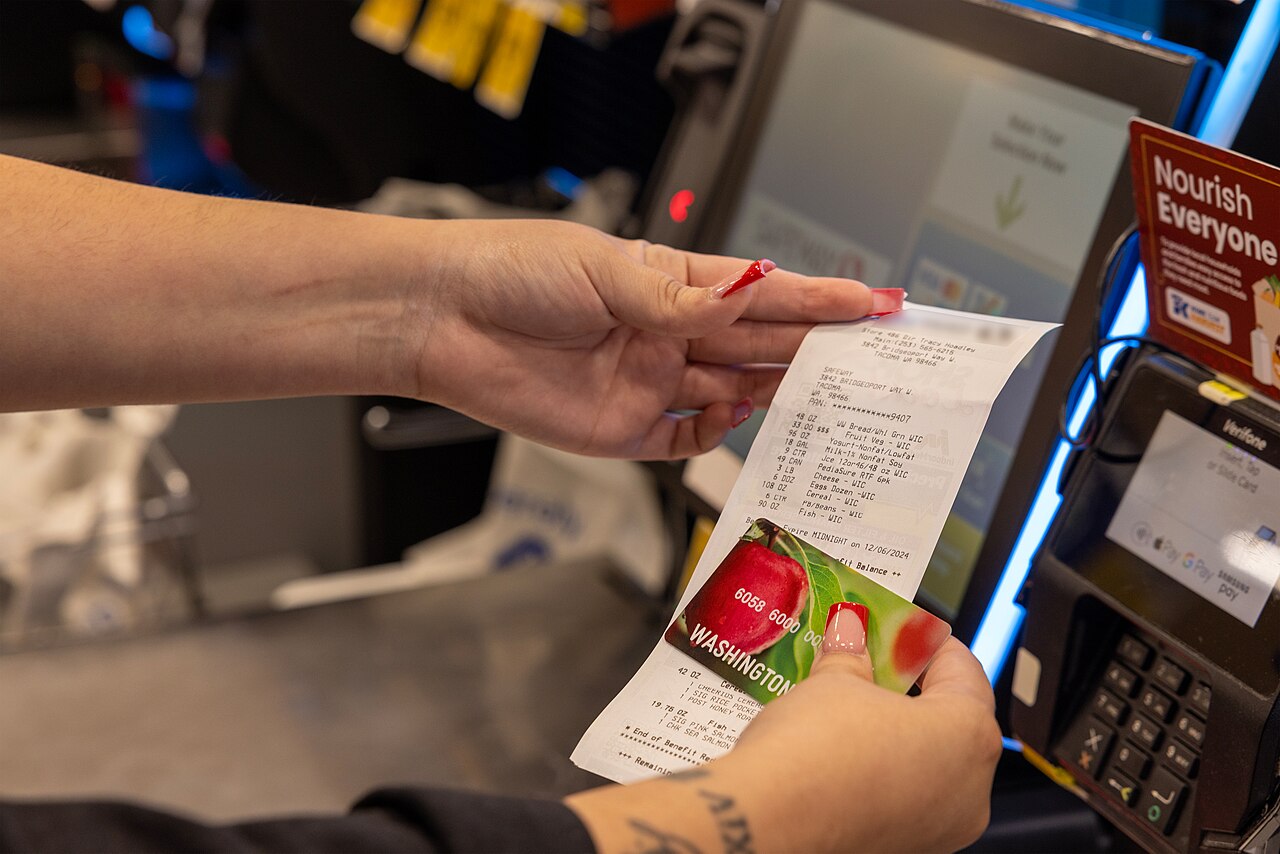 A shopper compares products at a grocery store