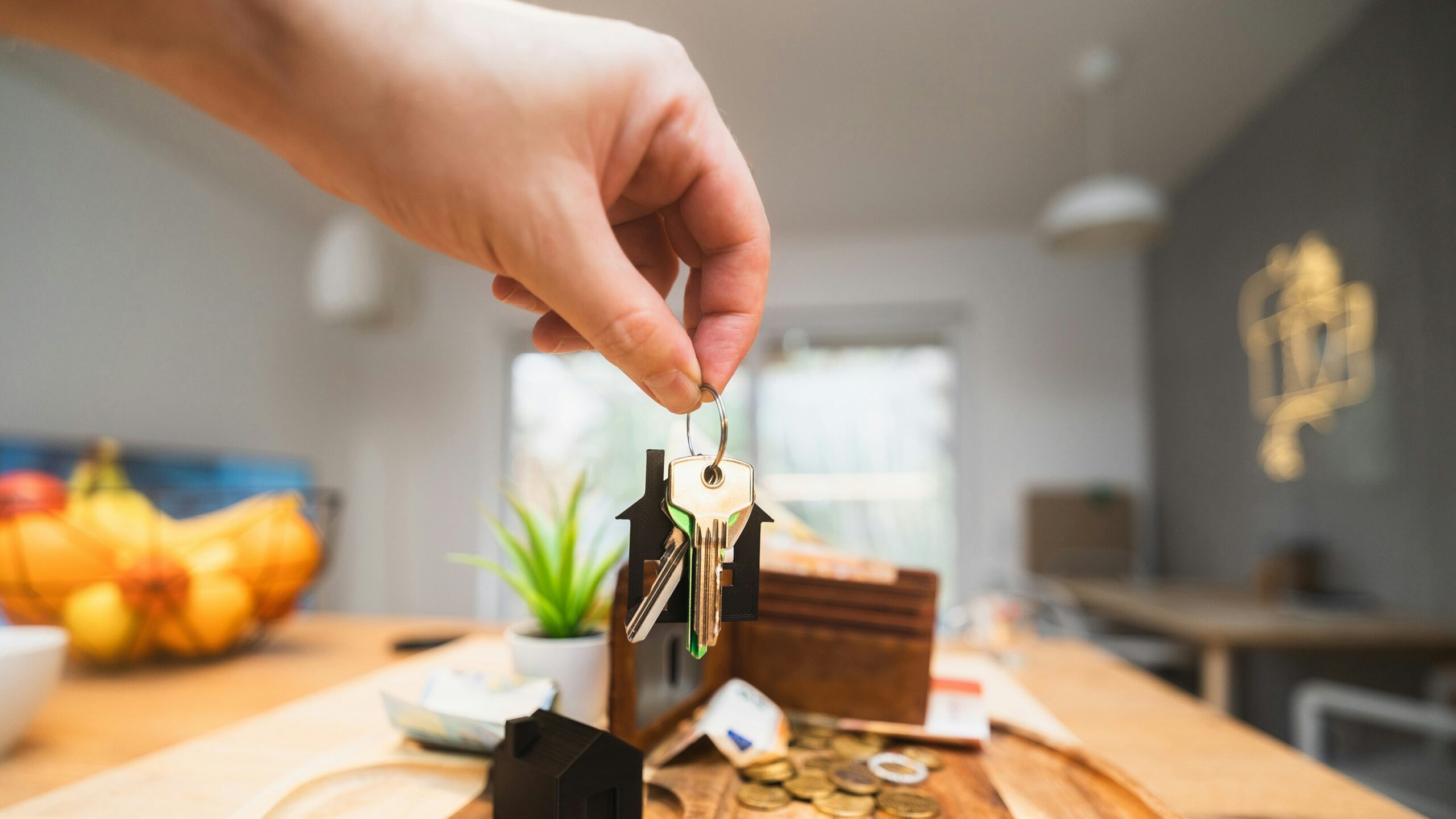 A person holding a piece of wood on top of a wooden table