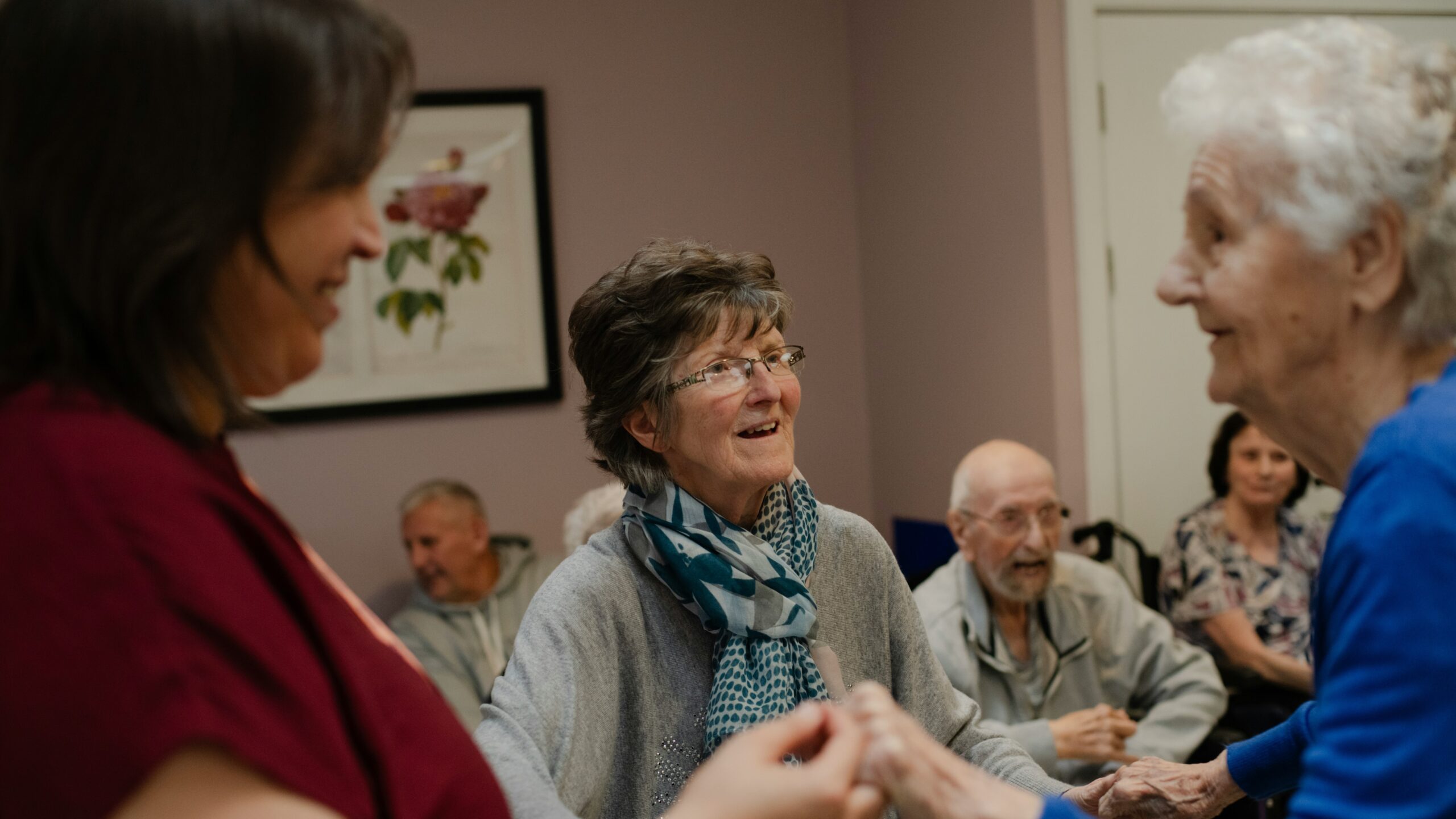 Elderly people enjoying a social gathering indoors.