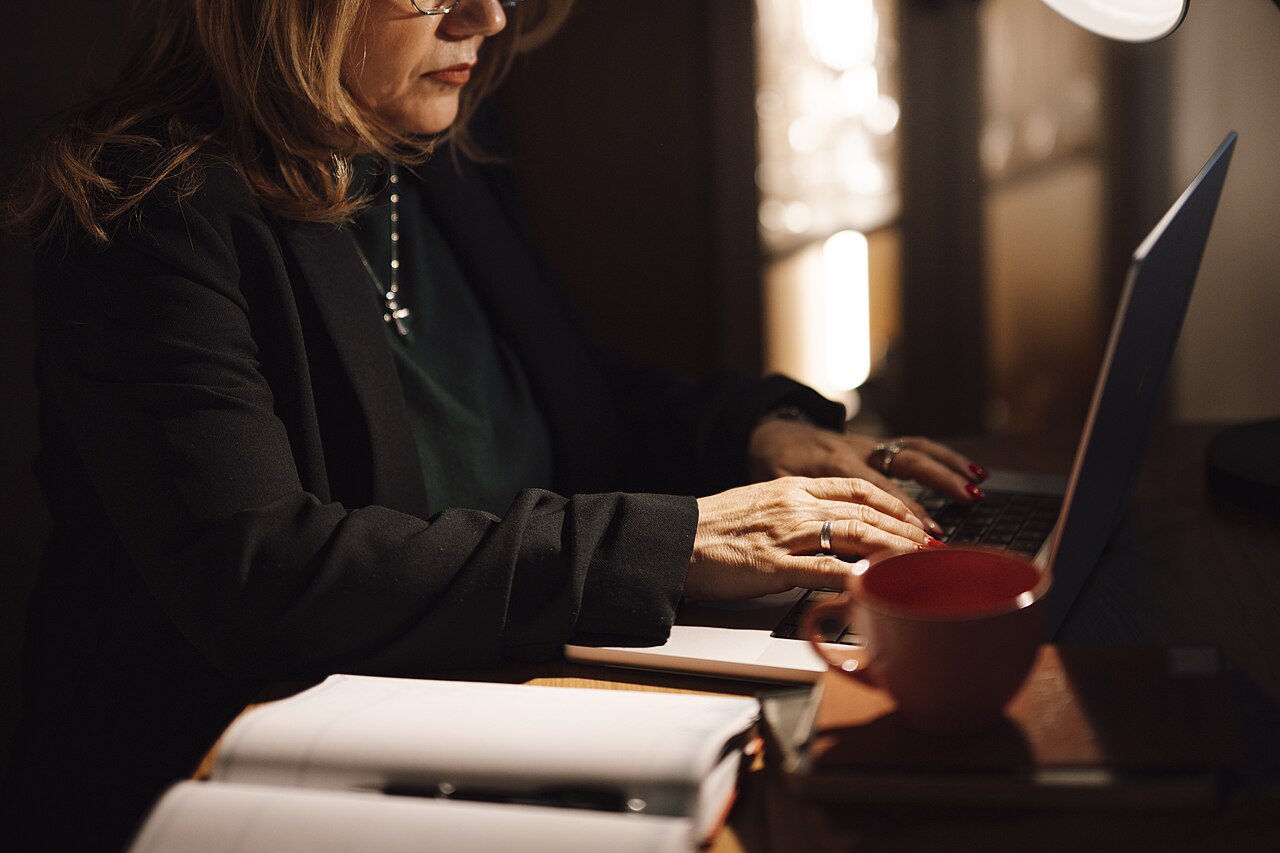 A woman prepares her tax return on a laptop at home