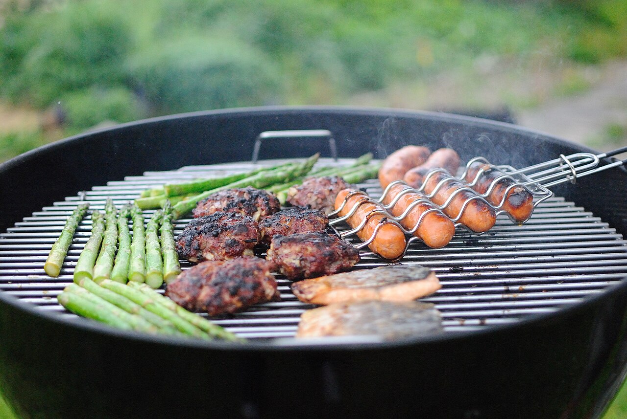 Hamburgers cooking on a backyard grill