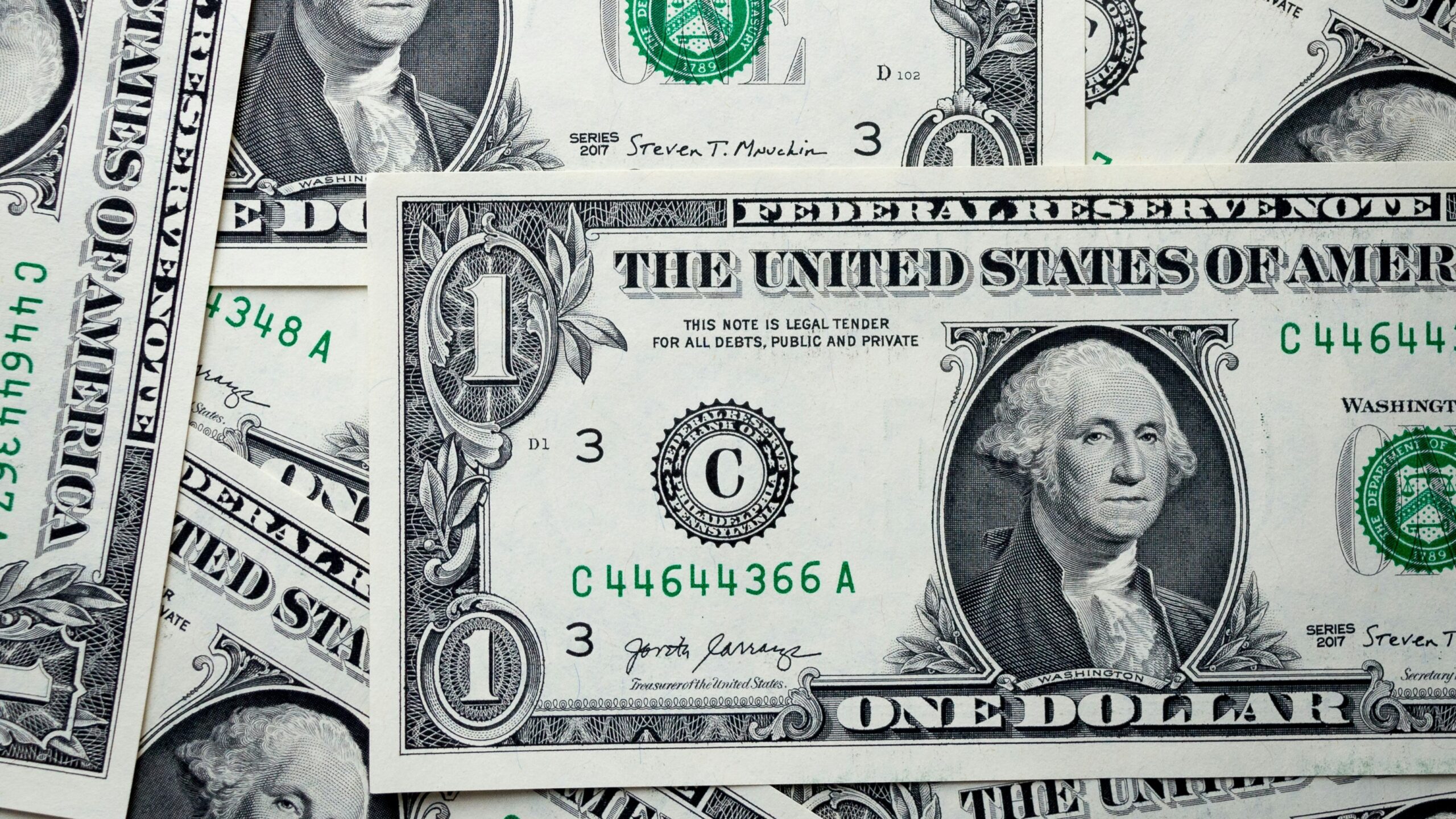 a pile of one hundred dollar bills