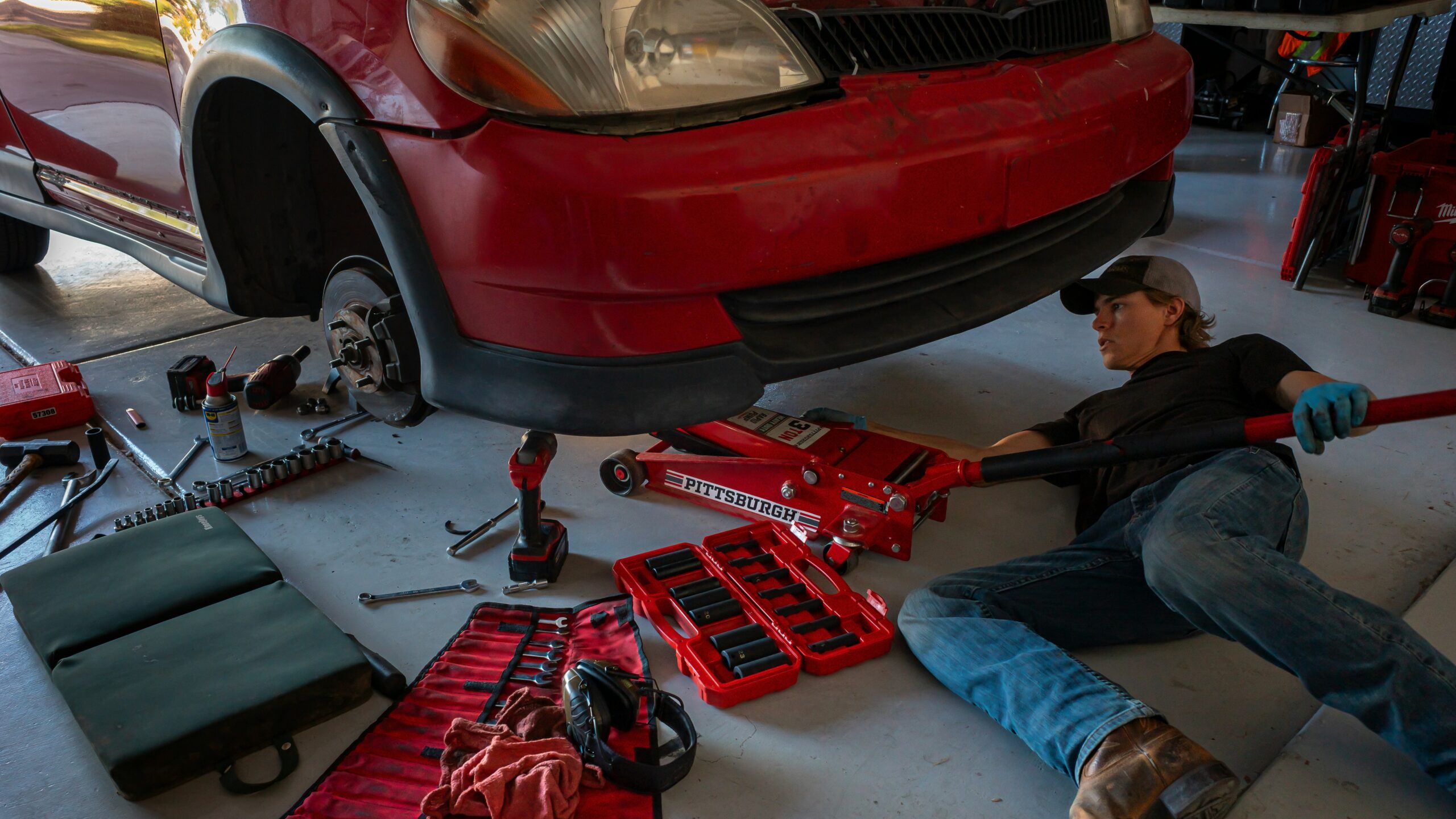 a man working on a car in a garage