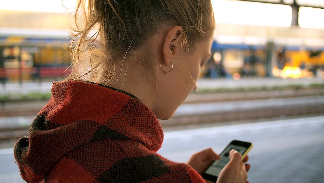A woman checks a message on her smartphone