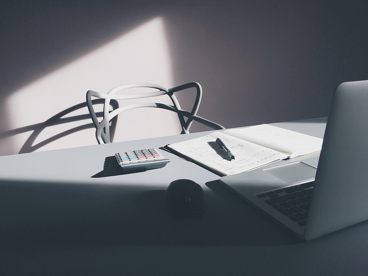 A calculator and laptop used to compare policy costs