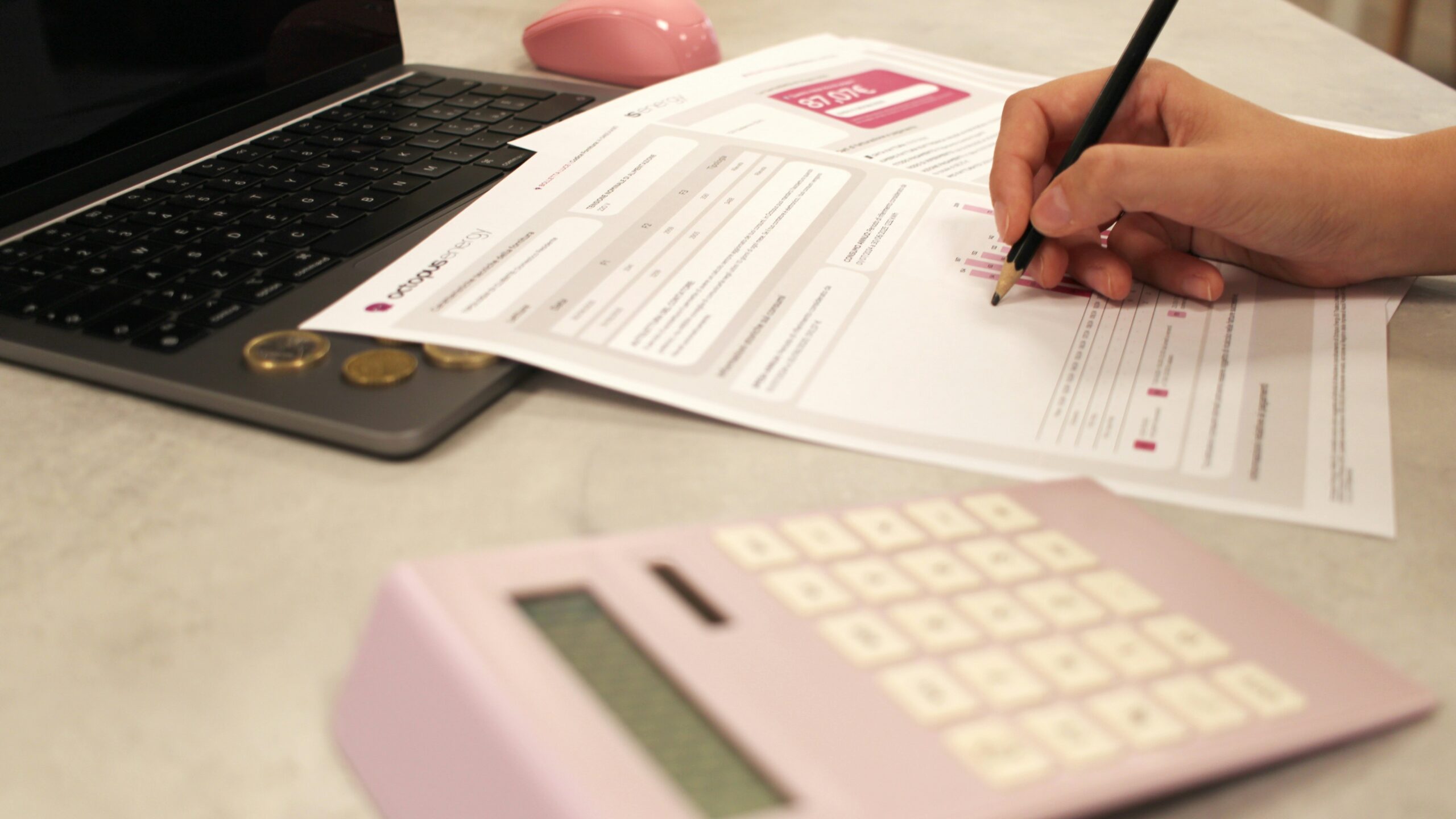 Someone is working on paperwork with a calculator.