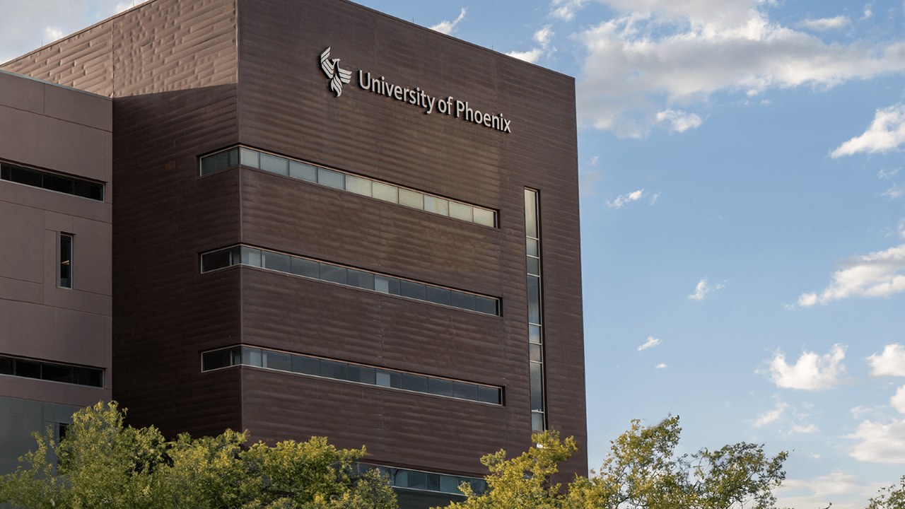 The Education Department says it will fully forgive loans for deceived University of Phoenix students